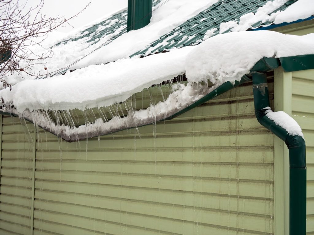 Roof covered in icicles, risk of water damage, house water damage, public adjuster.