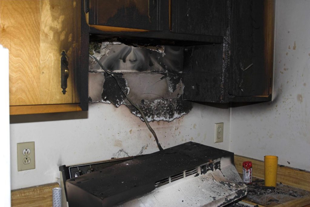 kitchen-fire-damage-with-burnt-cabinet-and-stove-area